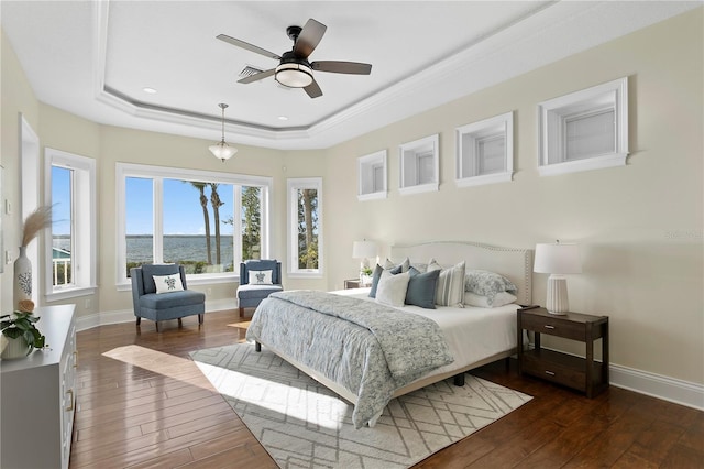 bedroom featuring a ceiling fan, a raised ceiling, baseboards, and dark wood-style flooring