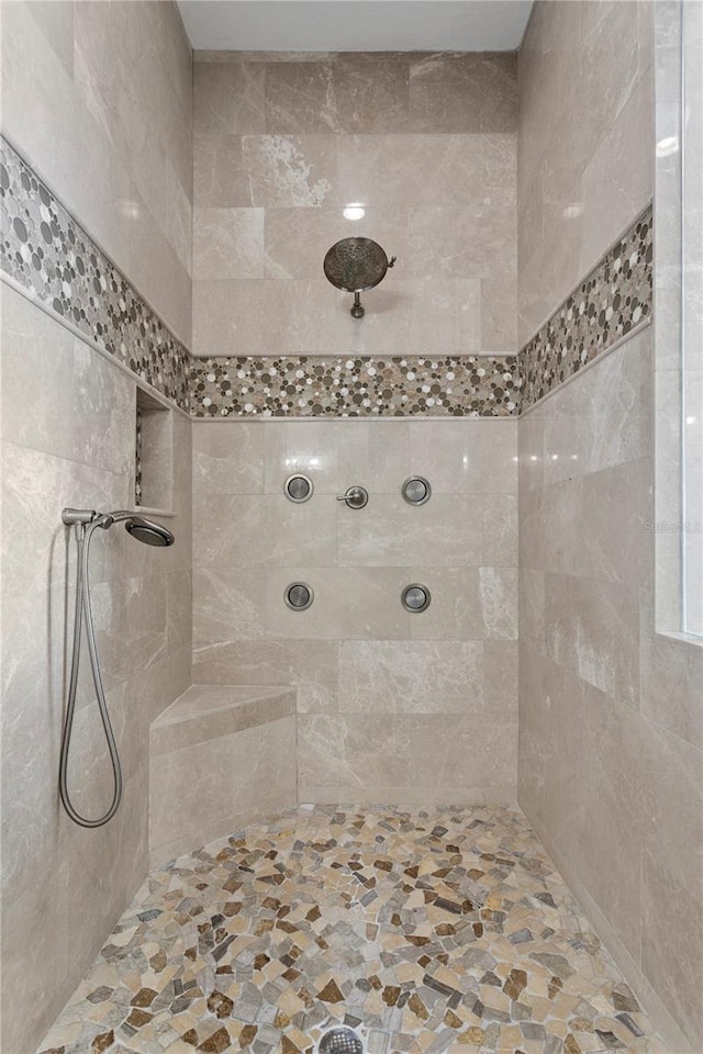 bathroom with tiled shower