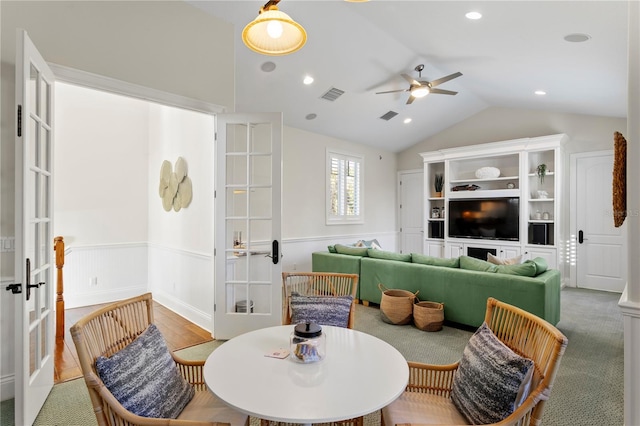 dining area featuring french doors, lofted ceiling, visible vents, and wainscoting