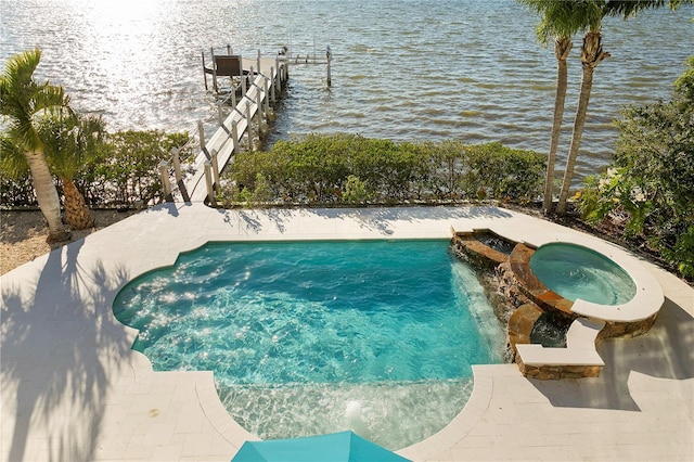 view of pool with an in ground hot tub and a water view