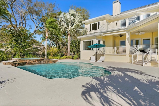 view of pool featuring a patio, a pool with connected hot tub, and a ceiling fan