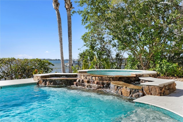 view of swimming pool with a pool with connected hot tub