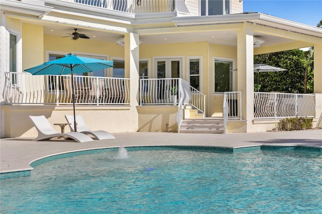 view of swimming pool with a patio, a fenced in pool, and ceiling fan