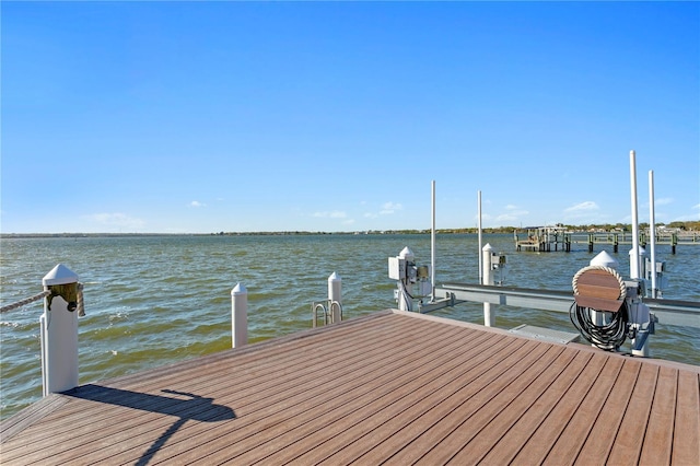 dock area with a water view and boat lift