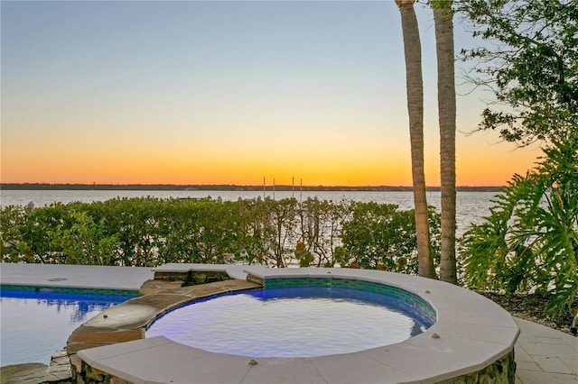 view of pool at dusk