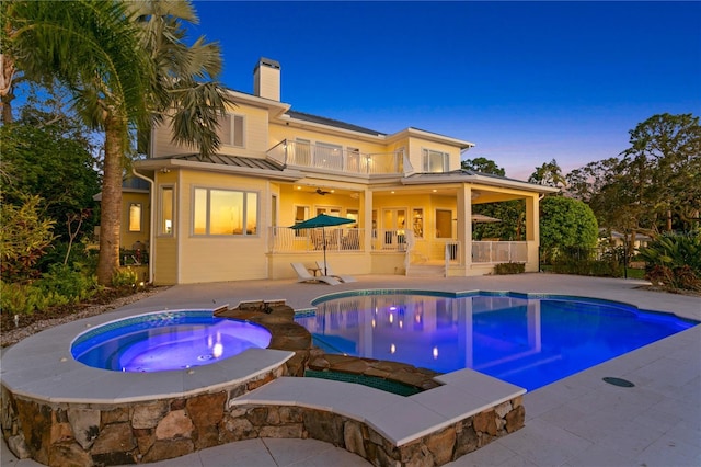 pool with a patio, an in ground hot tub, and ceiling fan