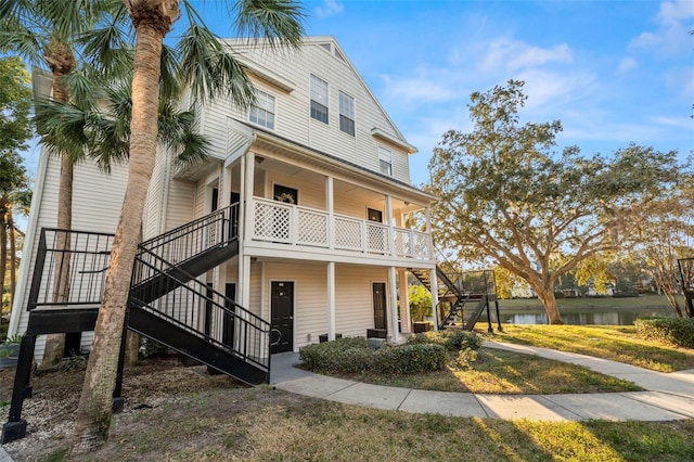 exterior space with a water view and covered porch