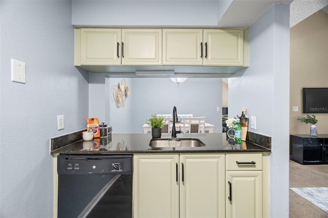 bar featuring black dishwasher, sink, dark stone counters, and cream cabinetry