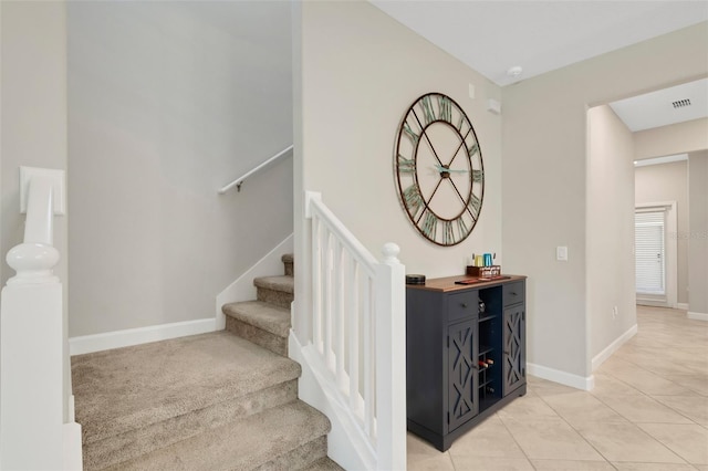 staircase featuring tile patterned floors