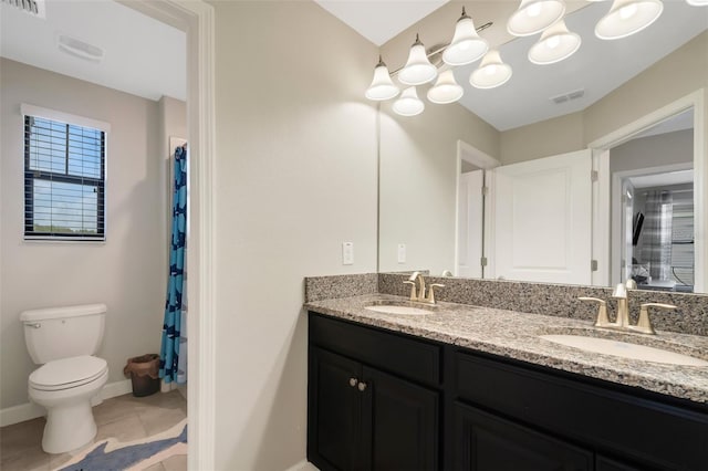 bathroom with tile patterned flooring, vanity, a shower with shower curtain, and toilet