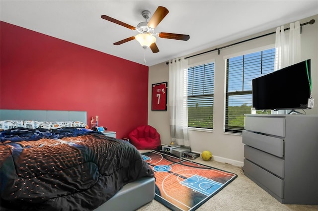 bedroom with ceiling fan and light carpet