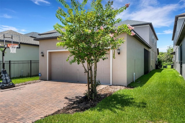 view of property exterior with a garage and a lawn