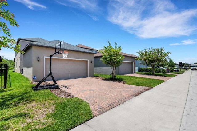 ranch-style home with a garage and a front yard