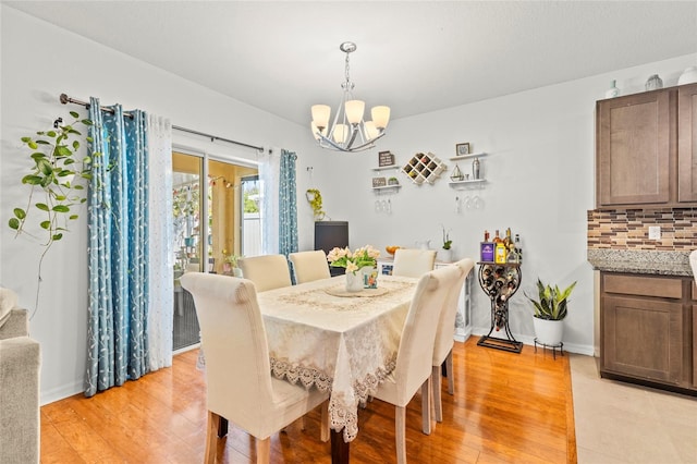 dining room featuring an inviting chandelier and light wood-type flooring