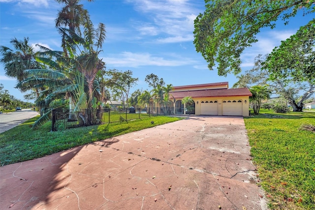 view of front of home with a garage and a front lawn