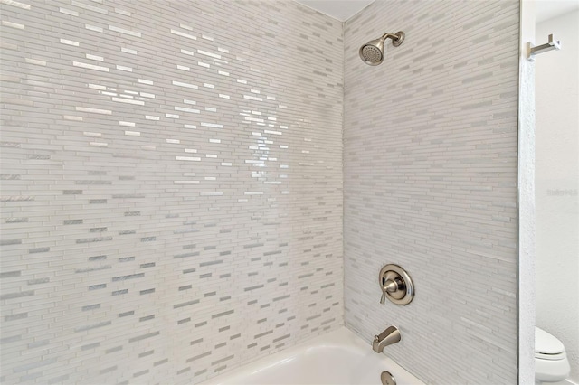 bathroom featuring toilet and shower / bathing tub combination