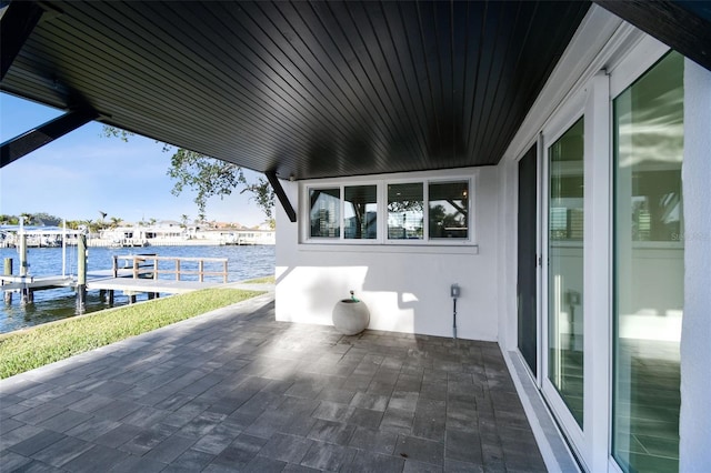 view of patio featuring a dock and a water view