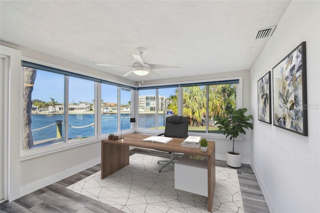 office with ceiling fan, light wood-type flooring, visible vents, and baseboards