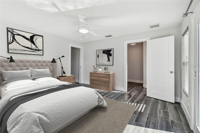 bedroom with baseboards, ceiling fan, visible vents, and wood tiled floor