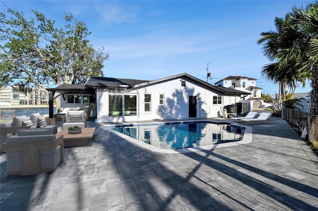 pool featuring an outdoor hangout area, a patio, and fence