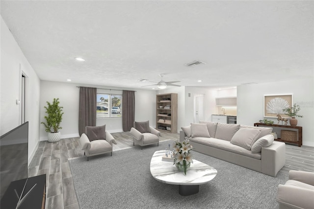 living room with recessed lighting, visible vents, ceiling fan, wood finished floors, and baseboards