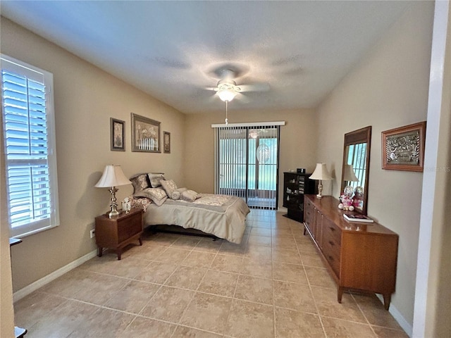 bedroom featuring multiple windows, baseboards, and light tile patterned flooring