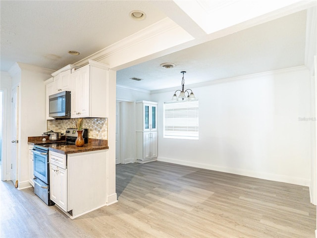 kitchen featuring stainless steel appliances, crown molding, hanging light fixtures, and white cabinets