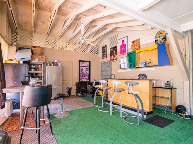 recreation room featuring high vaulted ceiling and ceiling fan