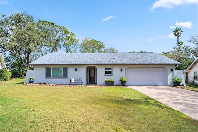 ranch-style house featuring a garage and a front yard