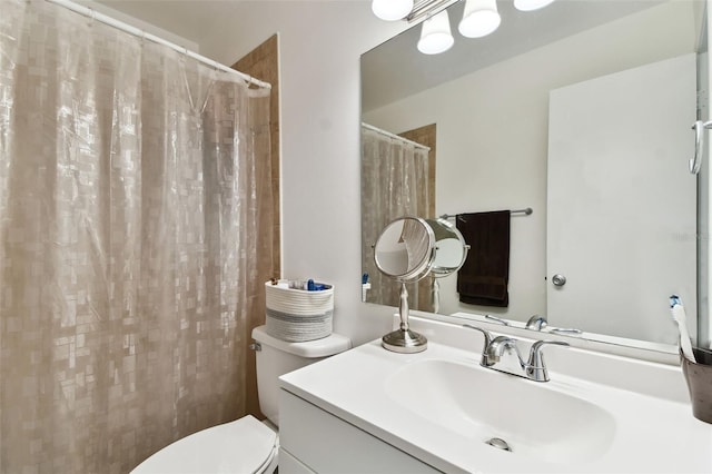 bathroom featuring vanity, toilet, and a shower with shower curtain