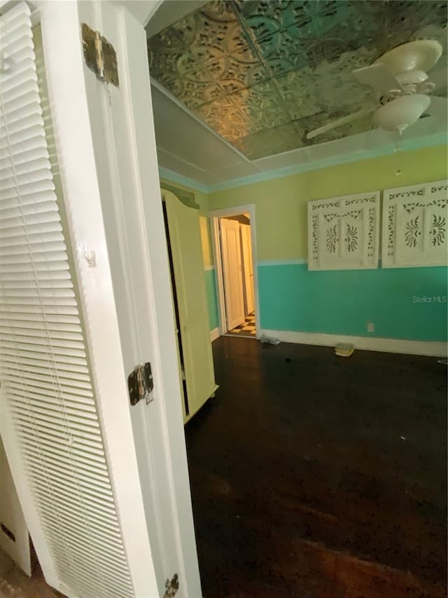 corridor with hardwood / wood-style flooring