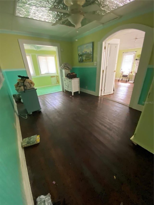 interior space with ornamental molding and dark hardwood / wood-style floors