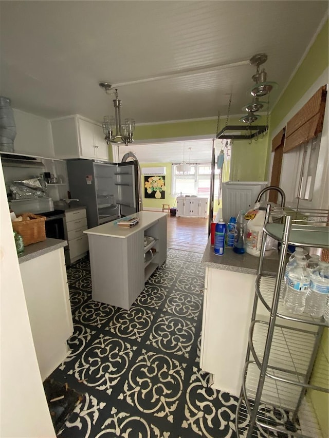 kitchen with white cabinetry, hanging light fixtures, and a center island