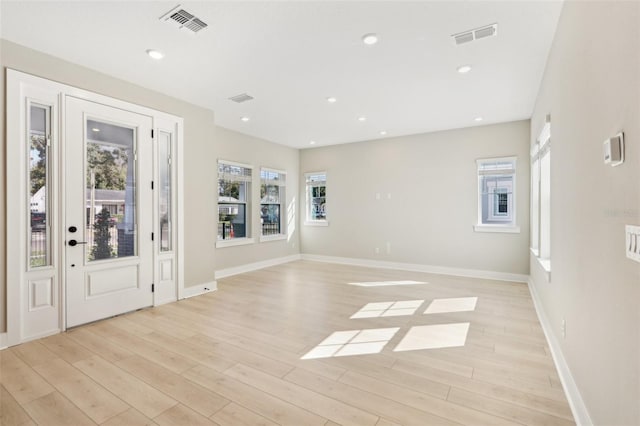 entrance foyer featuring light wood-type flooring, visible vents, baseboards, and recessed lighting