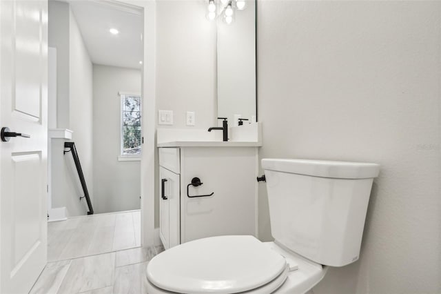 bathroom with toilet and vanity