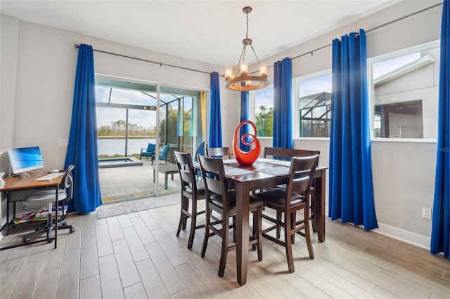 dining room featuring an inviting chandelier and light hardwood / wood-style flooring