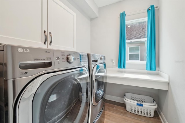 laundry area featuring cabinets and washing machine and dryer