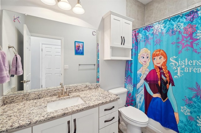 bathroom featuring vanity, a shower with curtain, and toilet