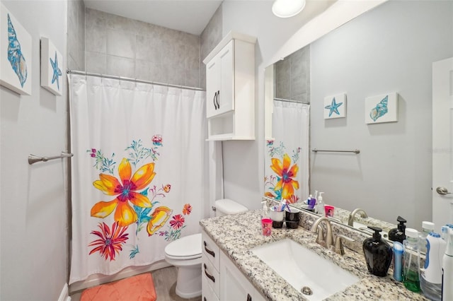 bathroom with a shower with curtain, vanity, and toilet