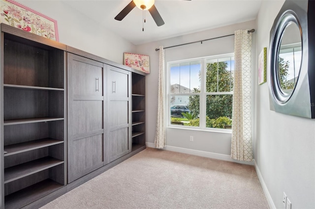 unfurnished bedroom featuring multiple windows, light carpet, and ceiling fan