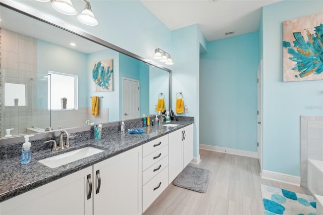 bathroom featuring vanity and an enclosed shower