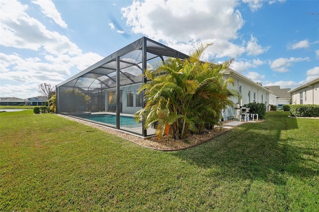 back of property featuring a yard and a lanai