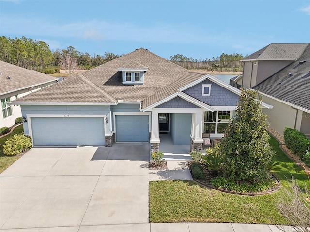 view of front of house featuring a garage and a front yard