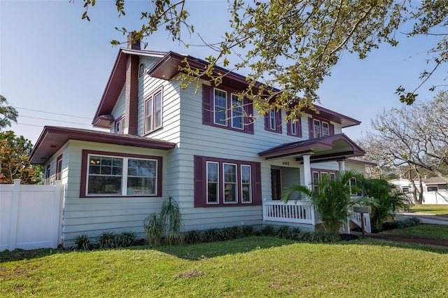 view of front of home with covered porch and a front yard