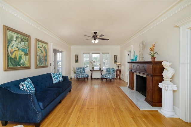 living room with hardwood / wood-style floors, crown molding, and ceiling fan