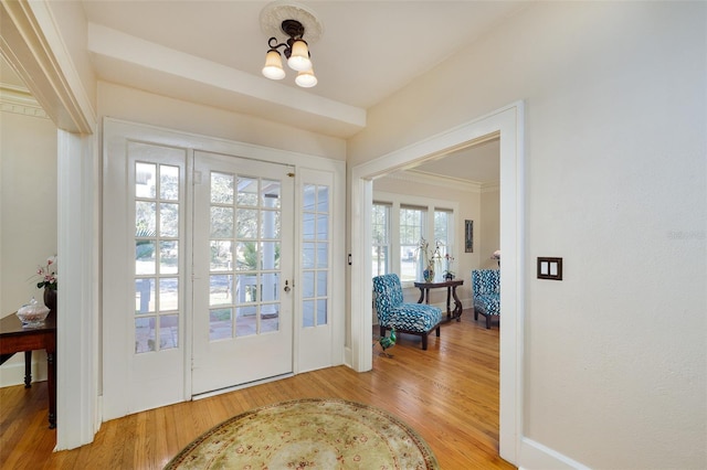 doorway to outside with hardwood / wood-style flooring and an inviting chandelier