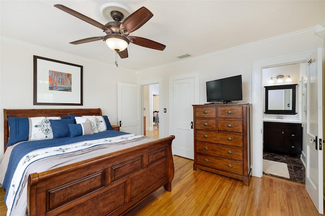 bedroom with ornamental molding, sink, ensuite bathroom, and light hardwood / wood-style flooring