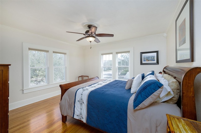 bedroom featuring crown molding, ceiling fan, and light hardwood / wood-style flooring