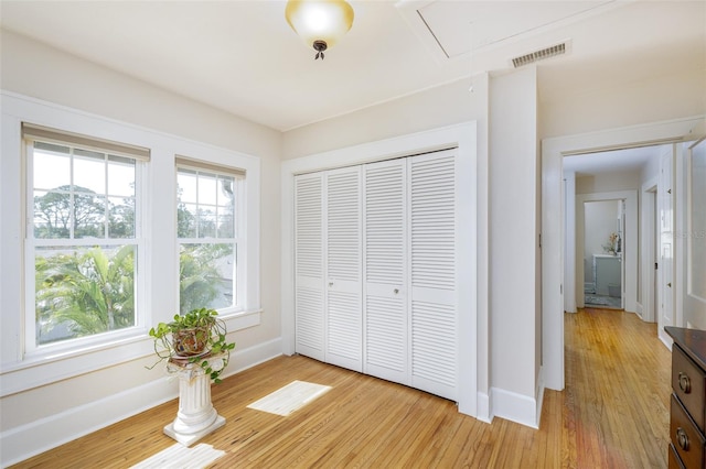 unfurnished bedroom with a closet and light wood-type flooring