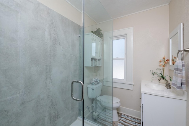 bathroom with vanity, crown molding, toilet, and walk in shower